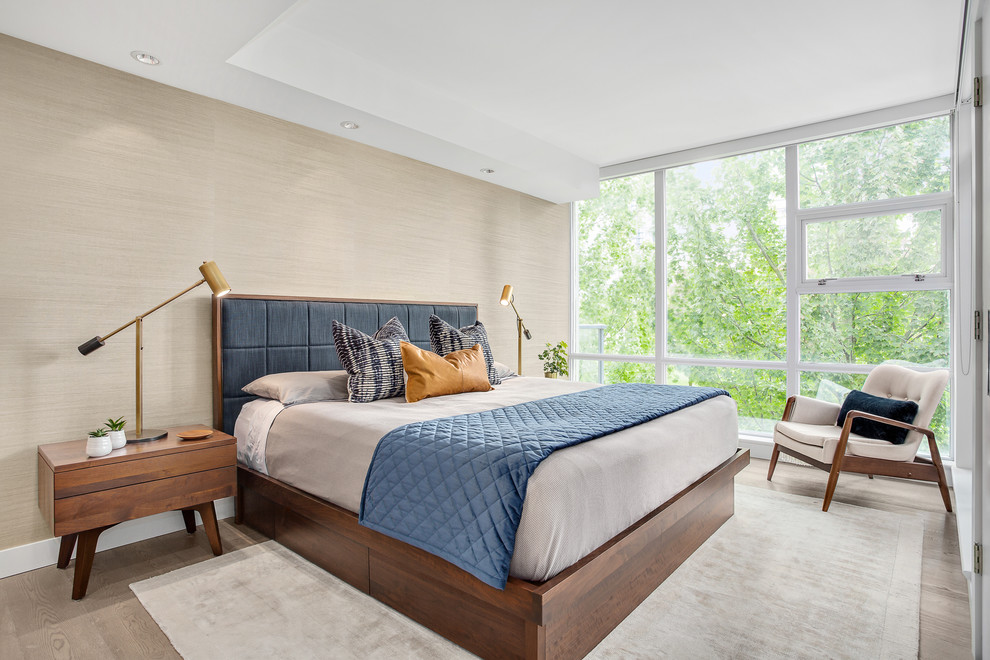 Medium sized contemporary master bedroom in Vancouver with beige walls, light hardwood flooring and brown floors.