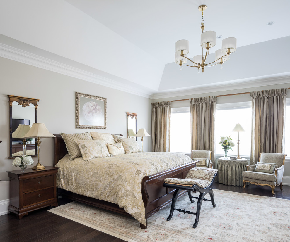 Photo of a large classic master bedroom in Toronto with dark hardwood flooring, beige walls and no fireplace.