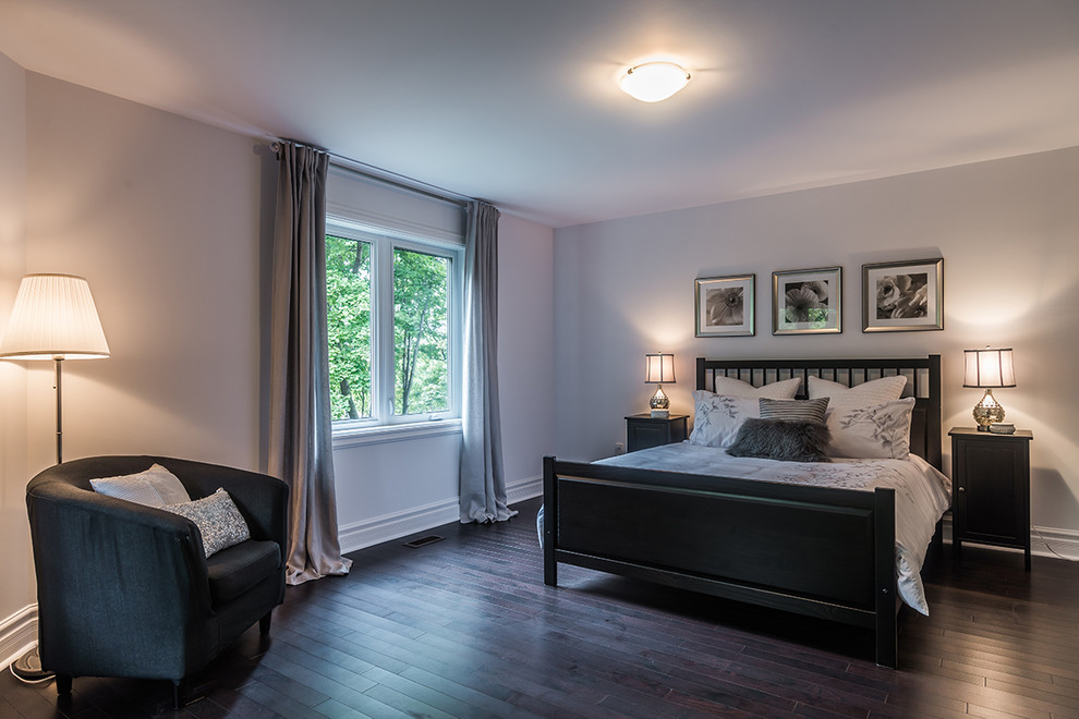 This is an example of a medium sized contemporary guest bedroom in Montreal with white walls and dark hardwood flooring.