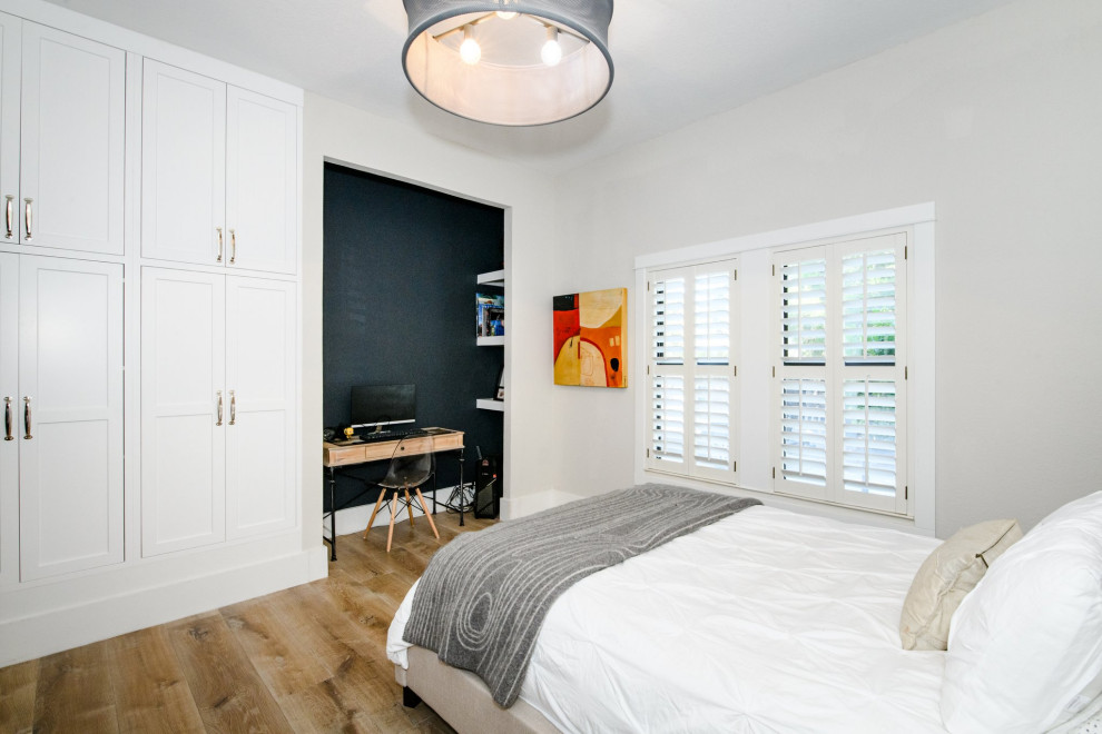 Mid-sized country medium tone wood floor and brown floor bedroom photo in San Francisco with gray walls and no fireplace