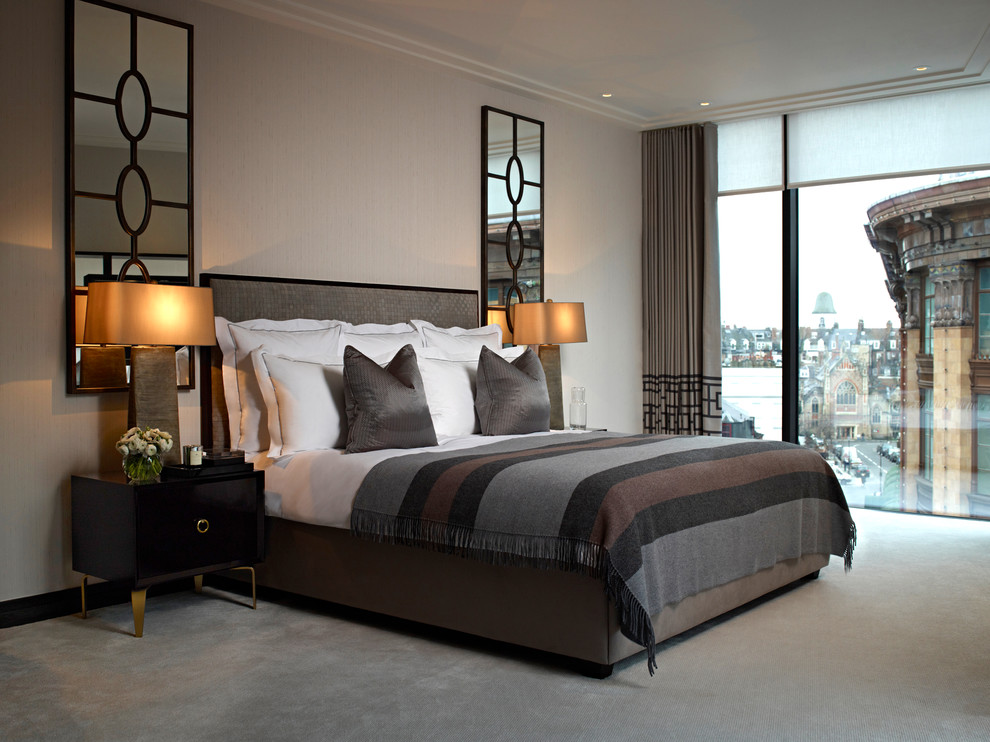 Inspiration for a large contemporary master bedroom in London with beige walls, carpet, no fireplace and beige floors.