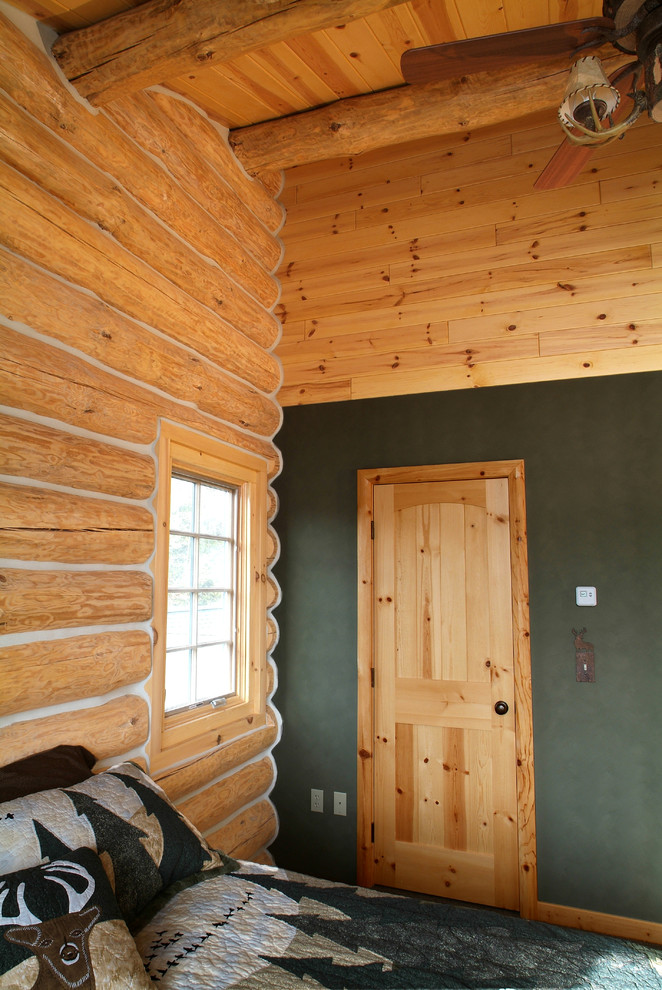 Knotty pine paneling and custom door Rustic Bedroom Other by