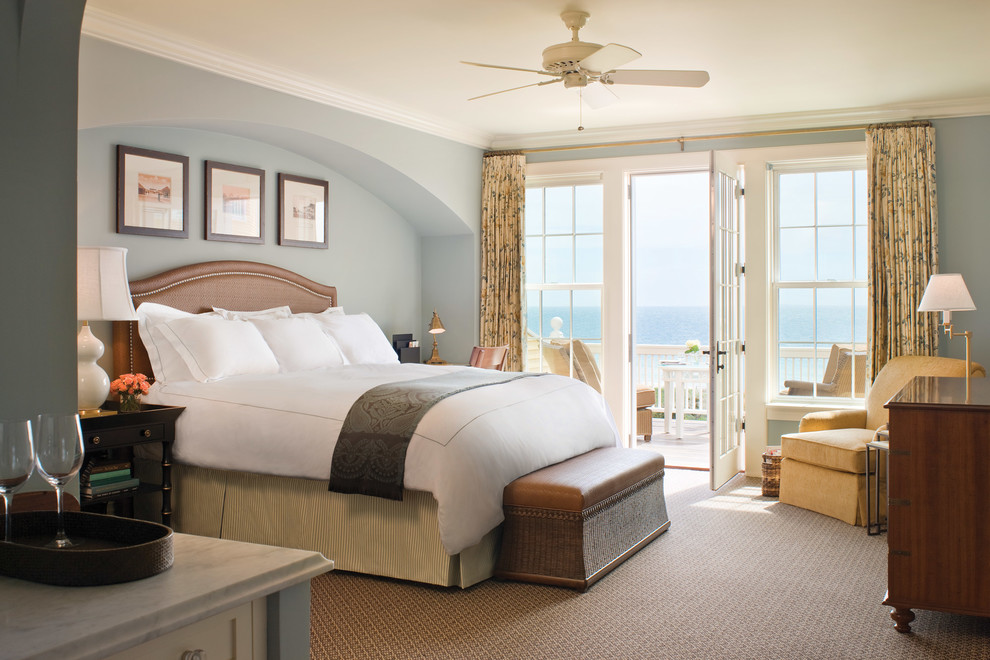 Example of a beach style carpeted and brown floor bedroom design in Other with blue walls