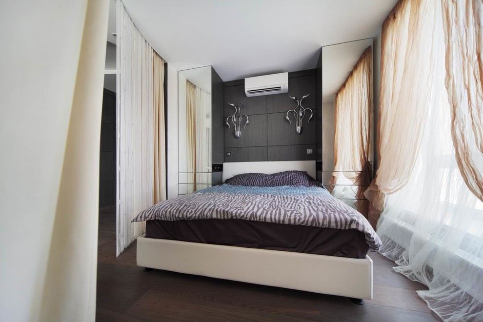 Esempio di una piccola camera da letto minimal con pareti nere, pavimento in legno massello medio e pavimento marrone