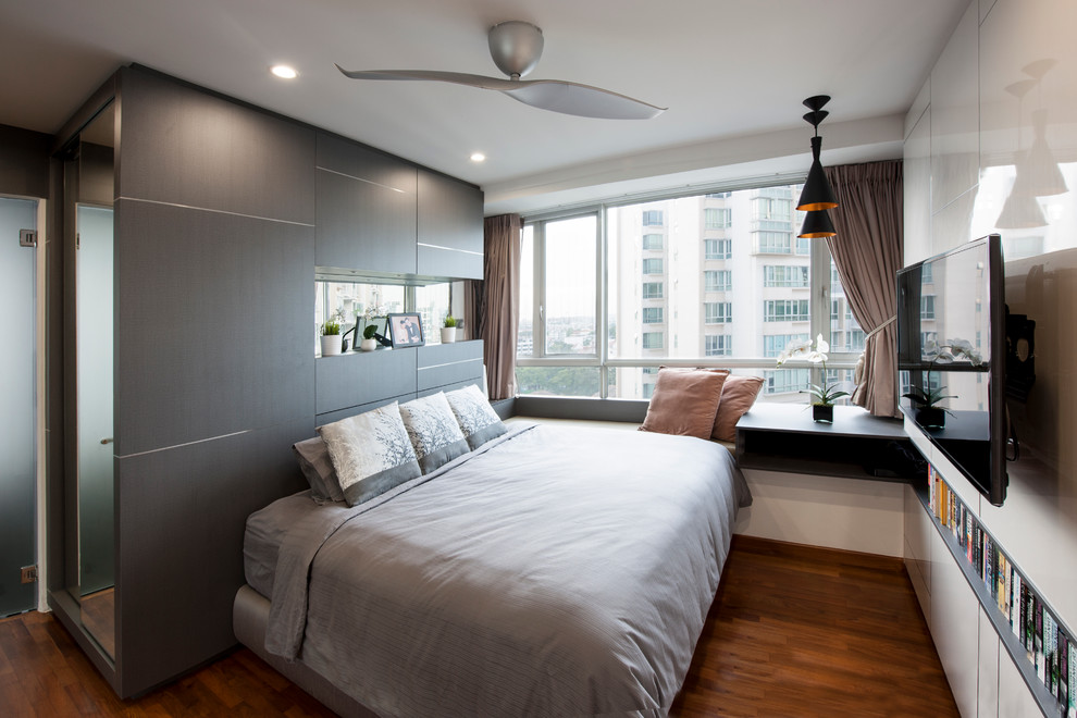 Inspiration for a small modern master bedroom in Singapore with white walls, medium hardwood flooring and no fireplace.