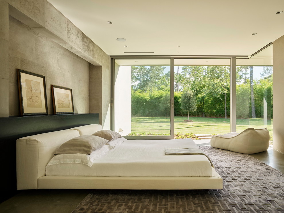 Modelo de dormitorio moderno con paredes grises, suelo de cemento y suelo gris