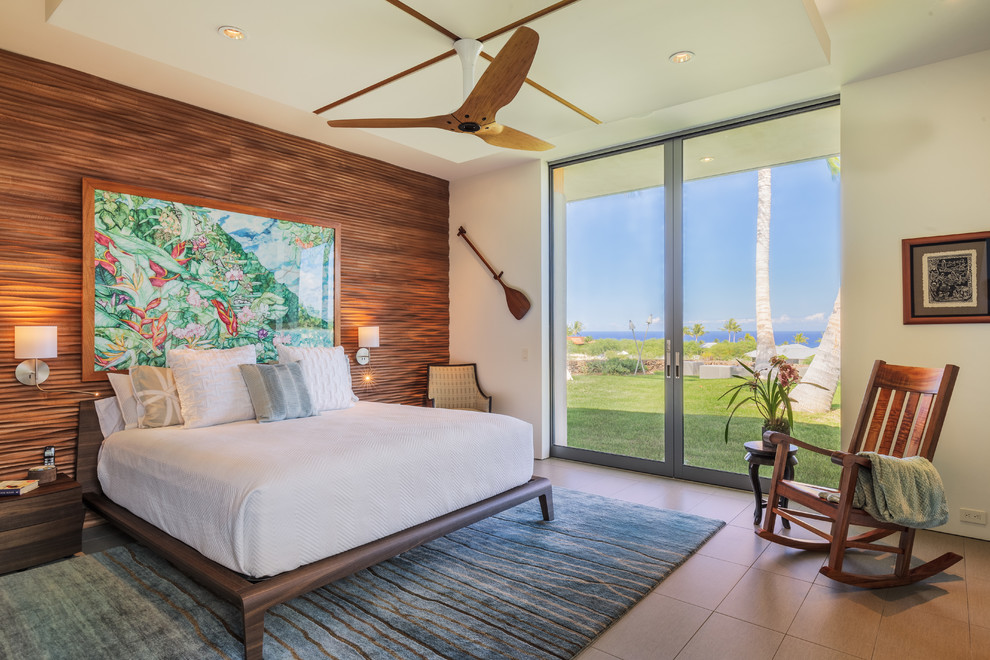 Medium sized world-inspired master bedroom in Hawaii with white walls, porcelain flooring, no fireplace and beige floors.