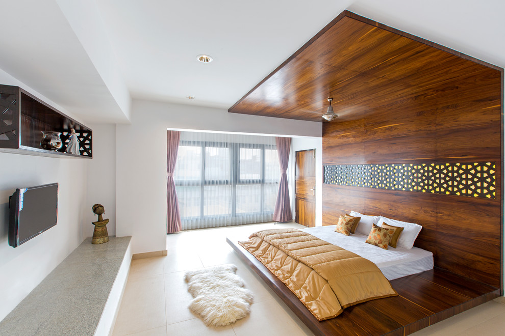 Contemporary master bedroom in Bengaluru with white walls.