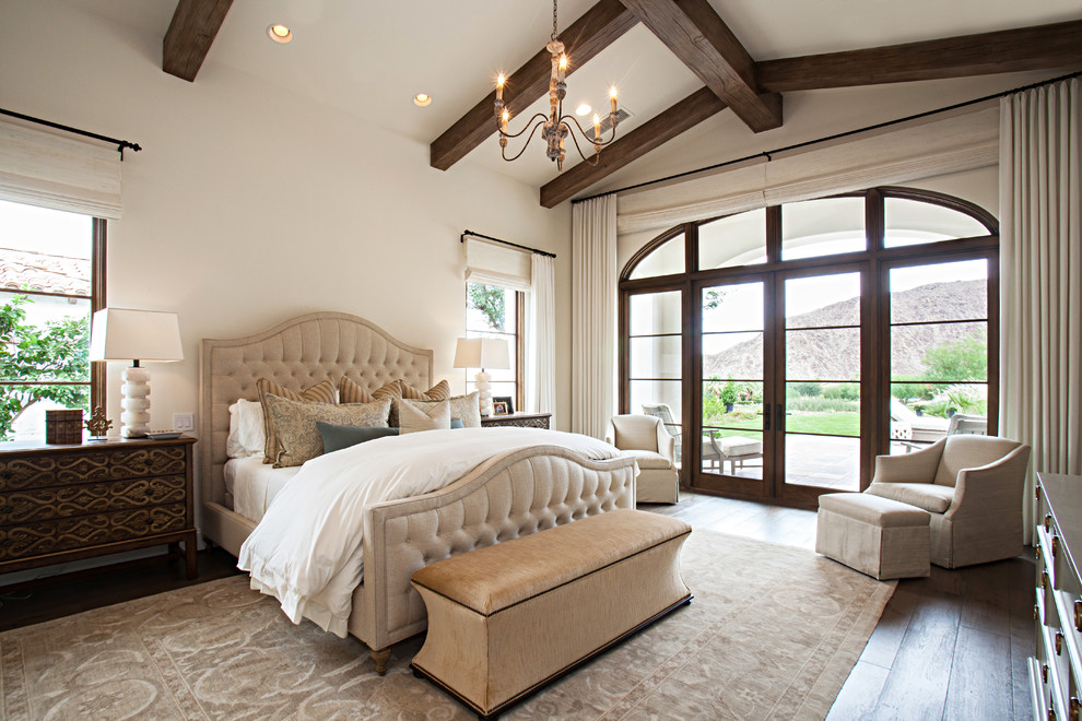 Inspiration for a large classic master bedroom in Los Angeles with white walls, dark hardwood flooring and feature lighting.