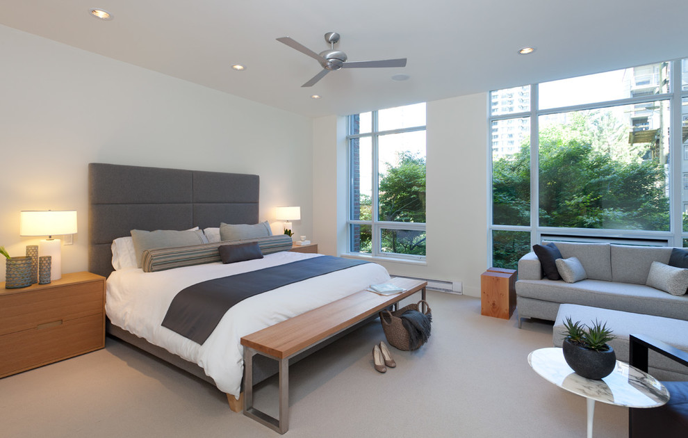 Photo of a contemporary bedroom in Vancouver with white walls and carpet.