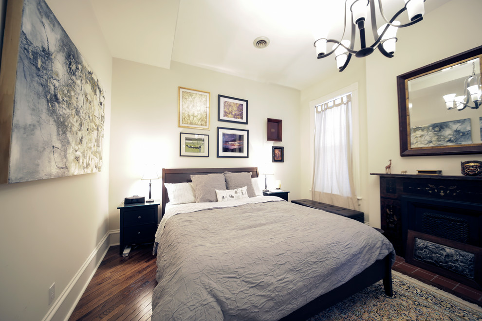 Modelo de habitación de invitados ecléctica de tamaño medio con suelo de madera en tonos medios y paredes beige