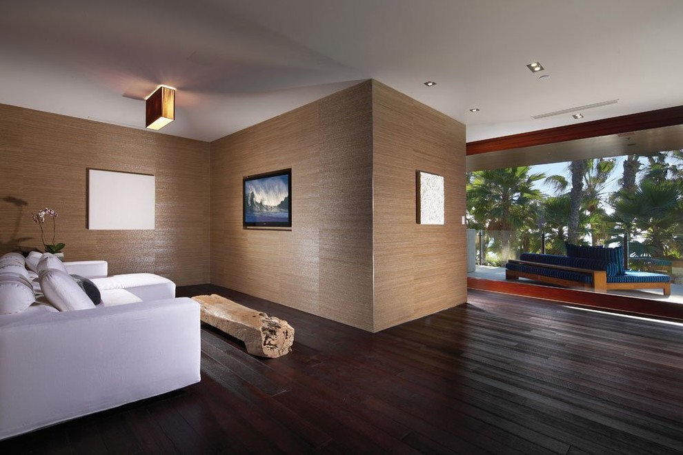 This is an example of an expansive contemporary master bedroom in Los Angeles with grey walls and dark hardwood flooring.