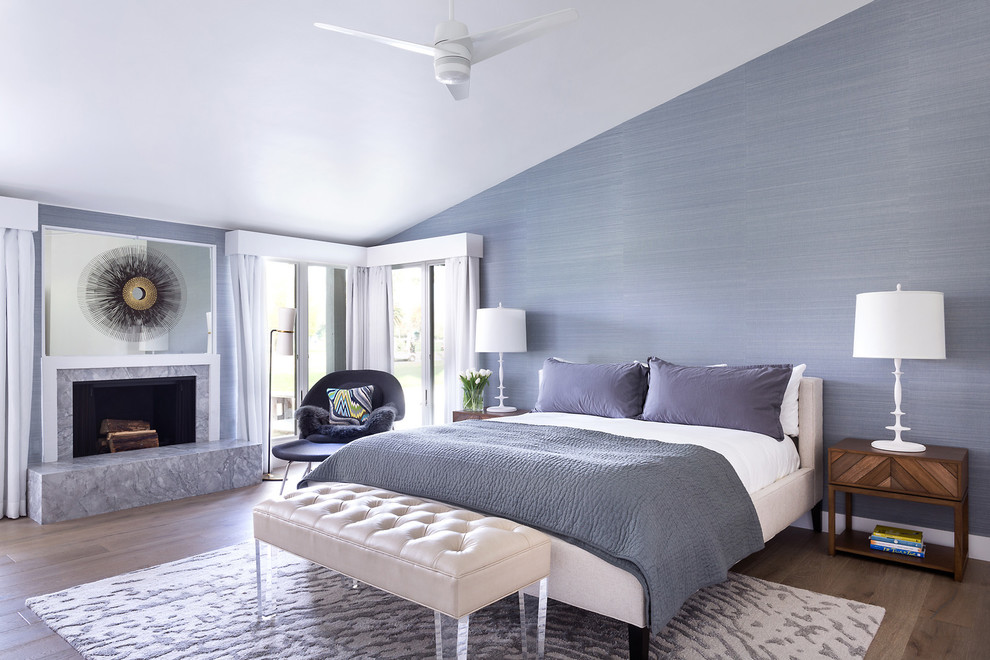 Example of a transitional master light wood floor bedroom design in Los Angeles with purple walls and a standard fireplace