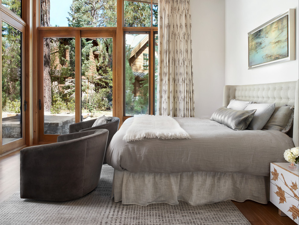 Example of a mid-sized transitional master medium tone wood floor and brown floor bedroom design in San Francisco with white walls