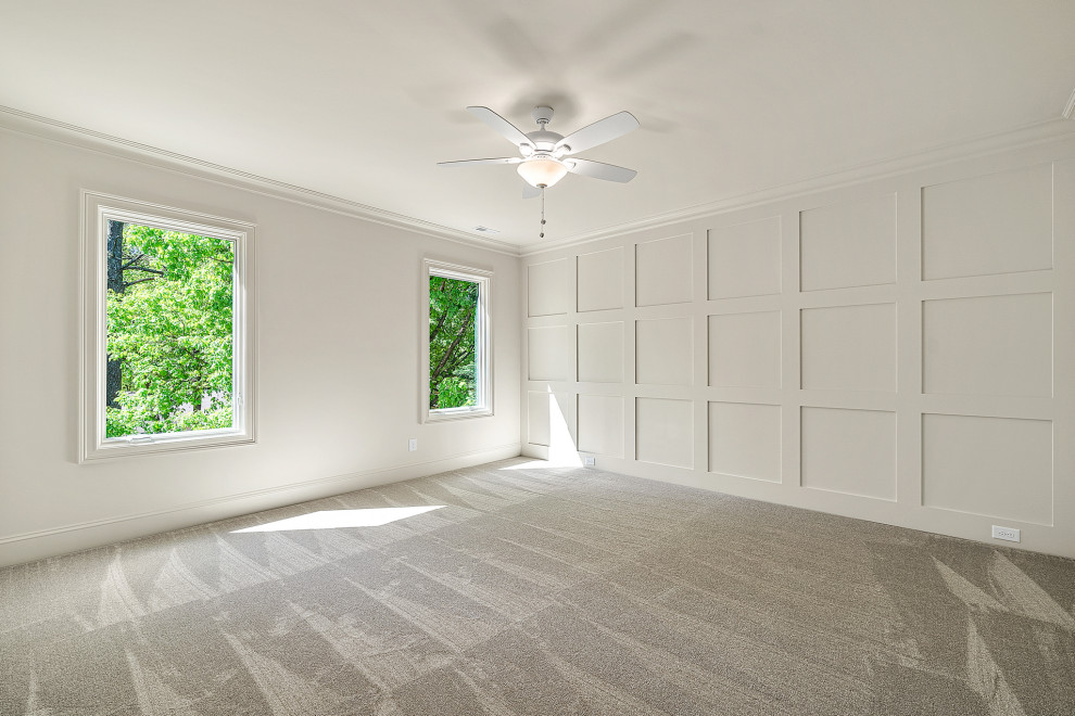 Design ideas for a large classic guest bedroom in Raleigh with white walls, carpet and white floors.