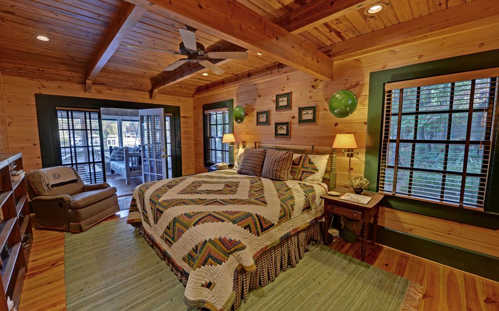 This is an example of a rustic grey and cream bedroom in Atlanta with medium hardwood flooring.