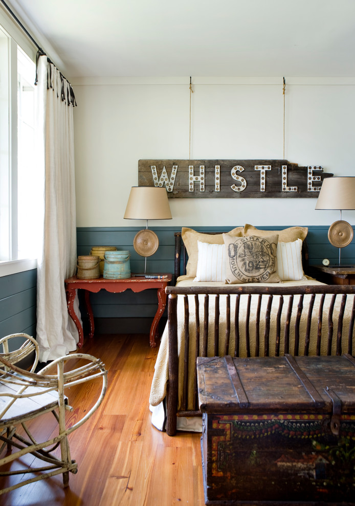 Inspiration for a rustic master medium tone wood floor and brown floor bedroom remodel in Atlanta with white walls