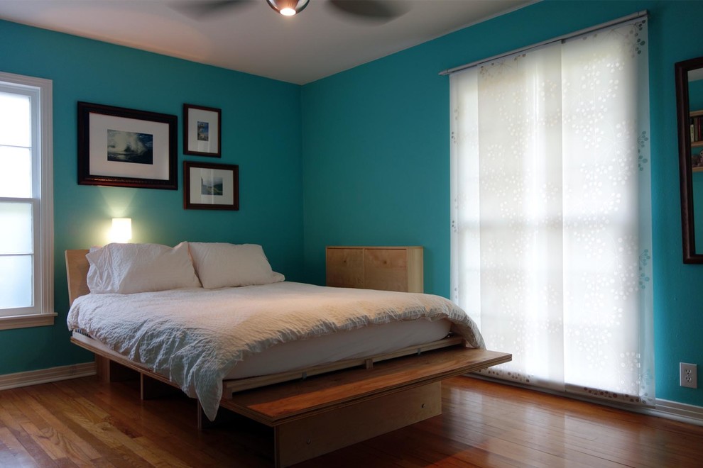 Design ideas for a medium sized contemporary master bedroom in Dallas with blue walls and medium hardwood flooring.