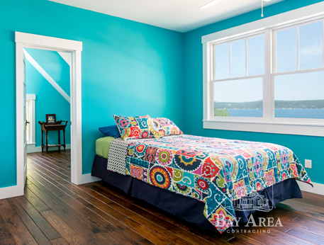 Design ideas for a classic guest bedroom in Other with blue walls, medium hardwood flooring and no fireplace.