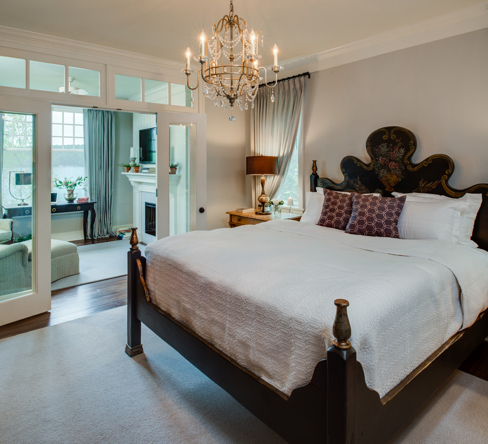 На фото: спальня в классическом стиле с серыми стенами, паркетным полом среднего тона, стандартным камином и коричневым полом