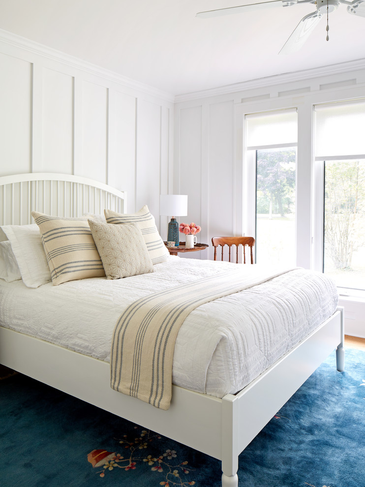 Mid-sized beach style master medium tone wood floor and brown floor bedroom photo in Toronto with white walls