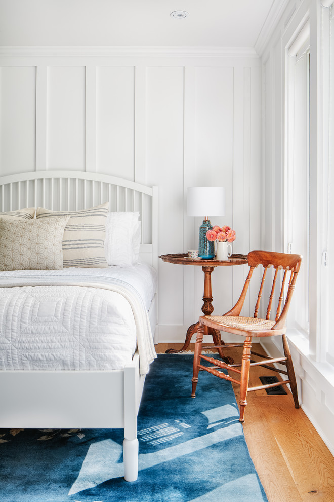Example of a mid-sized beach style master medium tone wood floor and brown floor bedroom design in Toronto with white walls