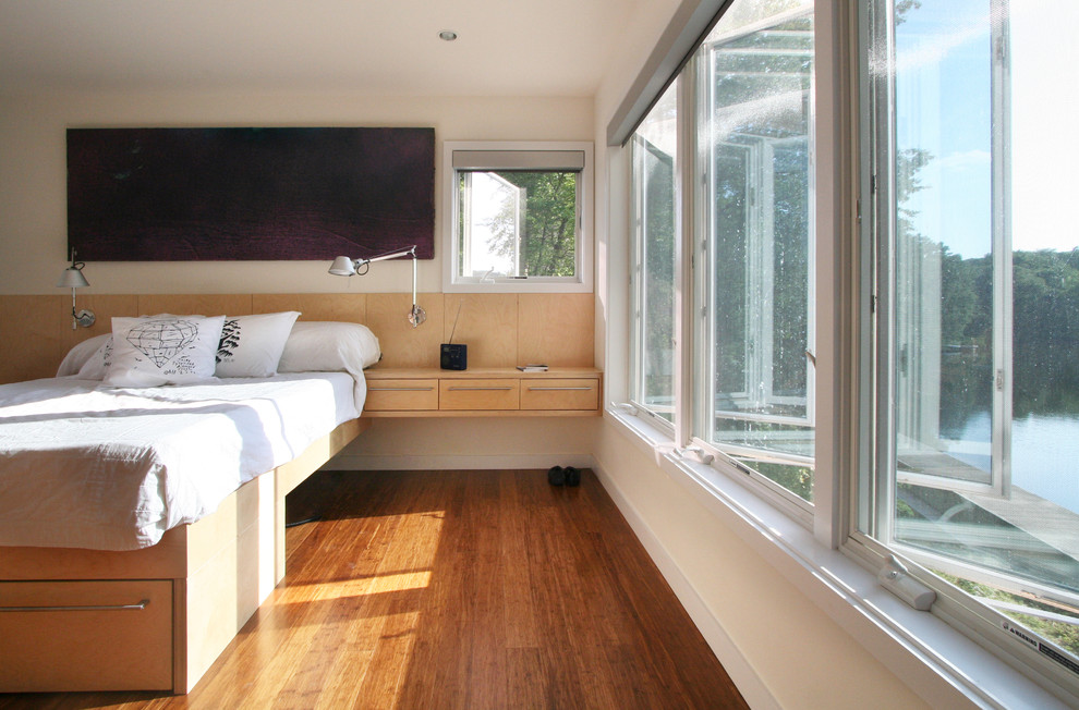 Design ideas for a modern bedroom in New York with bamboo flooring.