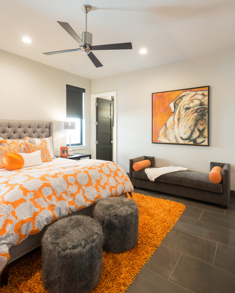 This is an example of a contemporary bedroom in Austin with beige walls and grey floors.
