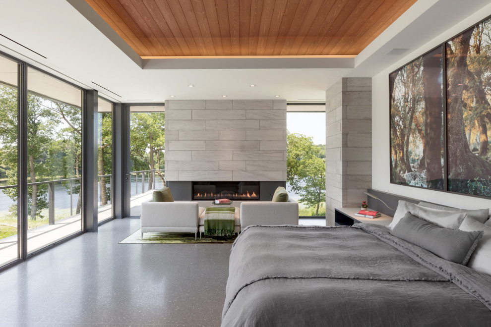 Example of a minimalist master gray floor, tray ceiling and wood ceiling bedroom design in Minneapolis with white walls and a ribbon fireplace