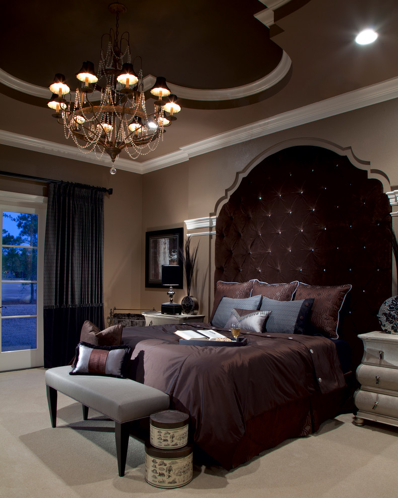 Inspiration for an expansive traditional master bedroom in Orlando with brown walls and carpet.