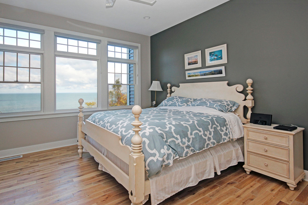 Design ideas for a nautical master bedroom in Grand Rapids with grey walls and light hardwood flooring.