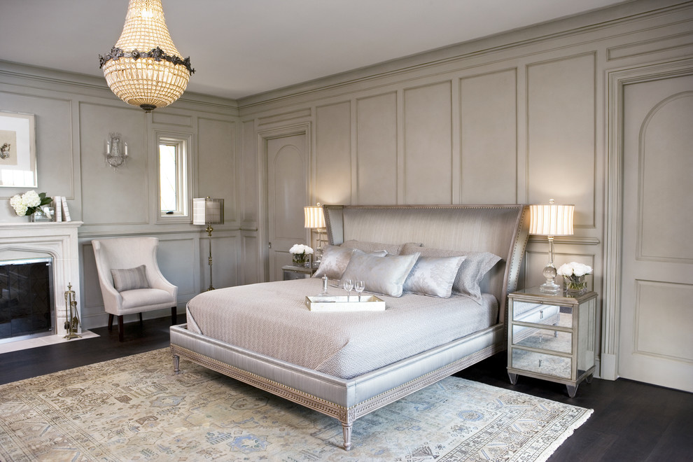 Inspiration for a large transitional master dark wood floor bedroom remodel in Other with gray walls, a standard fireplace and a stone fireplace