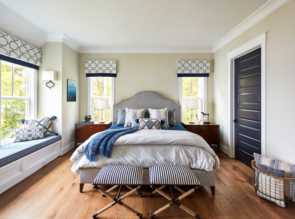 Nautical master bedroom in Raleigh with beige walls, dark hardwood flooring and no fireplace.