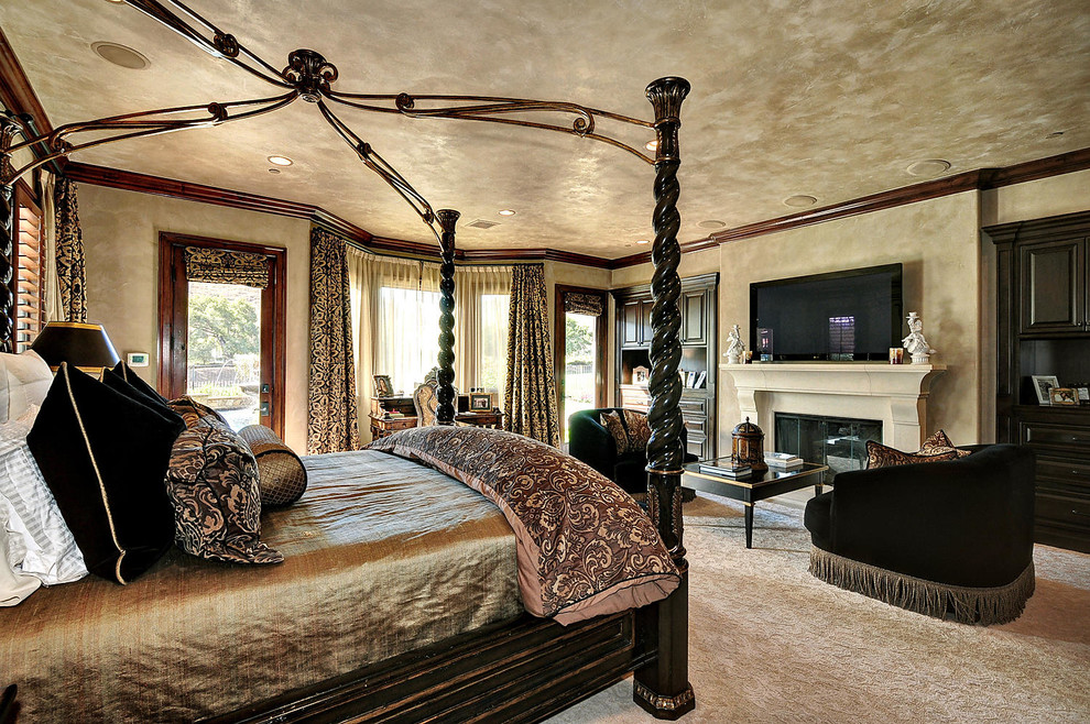Example of a huge tuscan master carpeted bedroom design in Los Angeles with brown walls, a standard fireplace and a stone fireplace