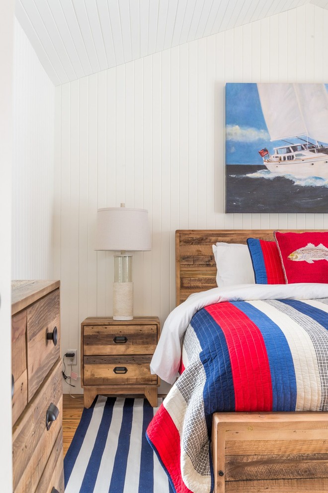 Photo of a medium sized coastal bedroom in Toronto with white walls and medium hardwood flooring.