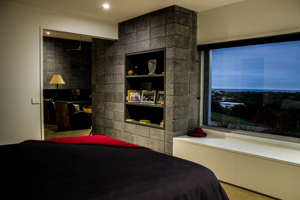 Photo of a medium sized modern master bedroom in Melbourne with white walls, concrete flooring and no fireplace.