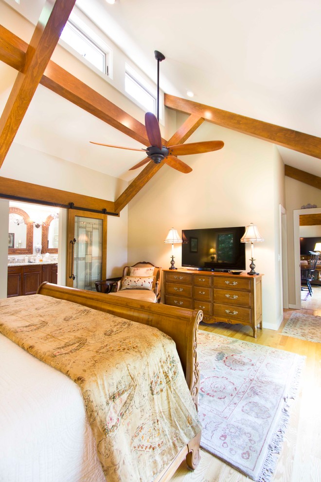 Design ideas for a large classic master bedroom in Other with beige walls, light hardwood flooring and no fireplace.