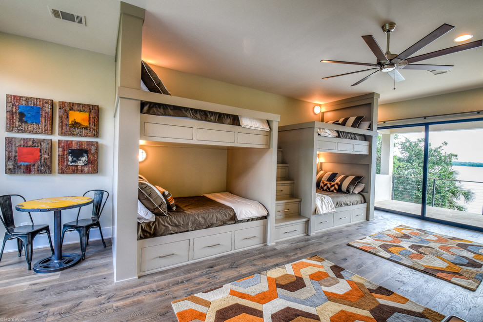 Imagen de habitación de invitados actual grande sin chimenea con paredes beige, suelo de madera clara y suelo marrón