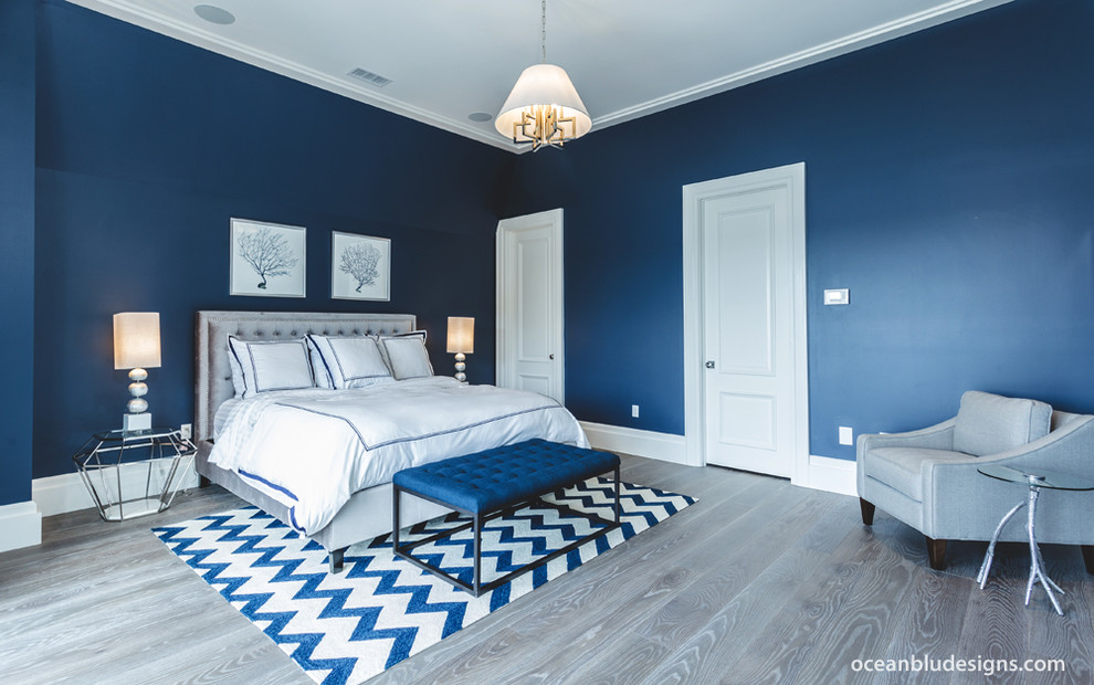 Expansive contemporary master bedroom in New York with blue walls.