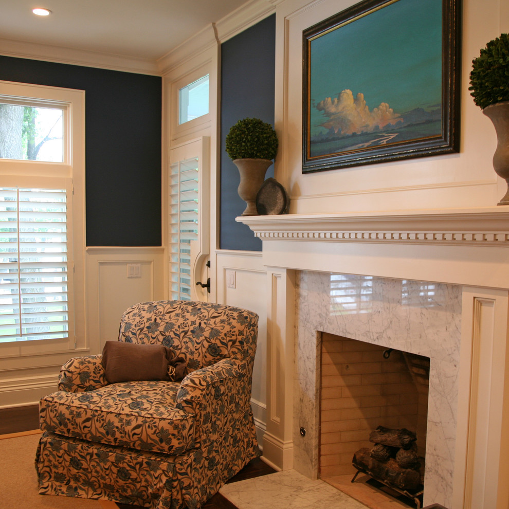 Exemple d'une chambre parentale chic avec un mur bleu, une cheminée standard et un manteau de cheminée en bois.