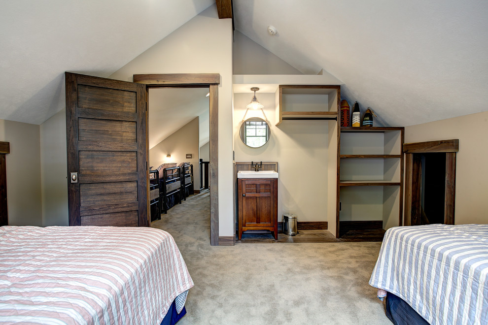 This is an example of a medium sized classic guest bedroom in Grand Rapids with beige walls and carpet.