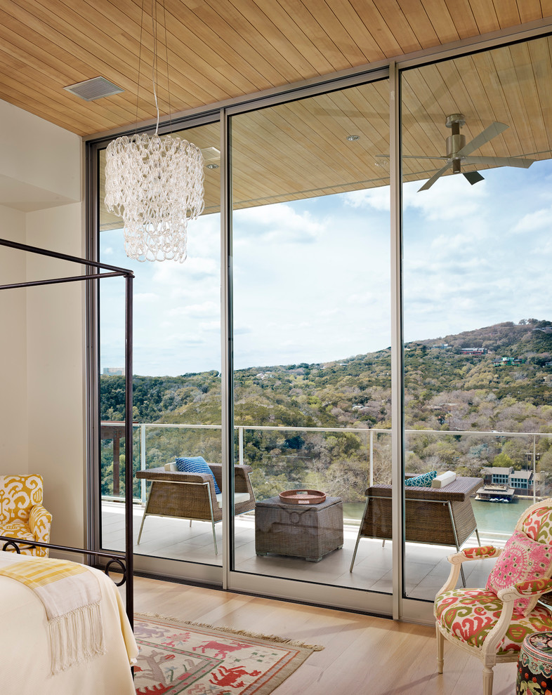 Inspiration for a contemporary bedroom in Austin with white walls and light hardwood flooring.