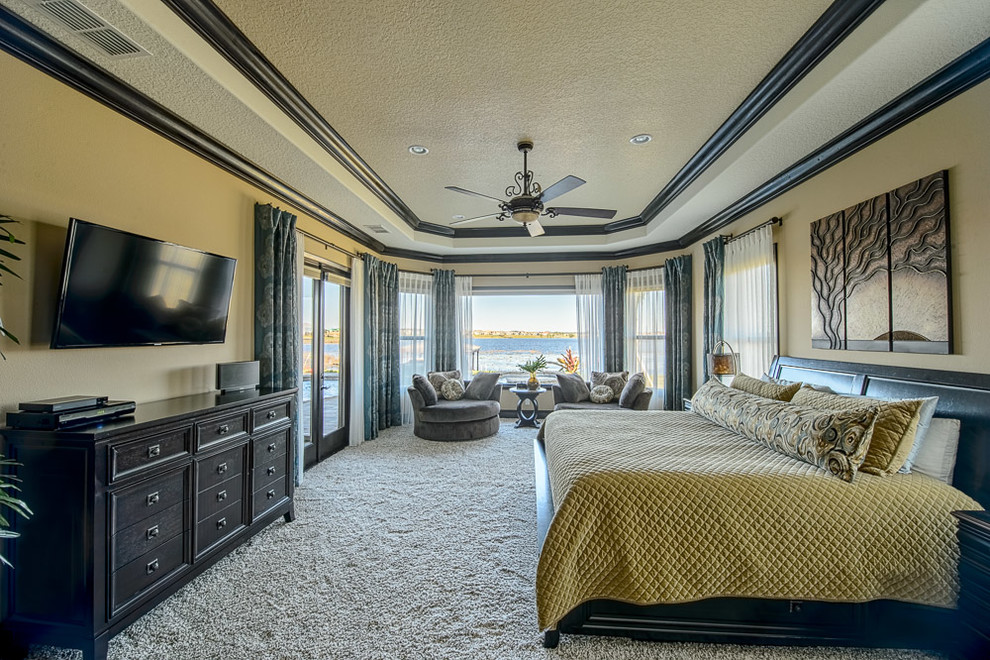 Inspiration for a large eclectic master carpeted bedroom remodel in Orlando with beige walls and no fireplace