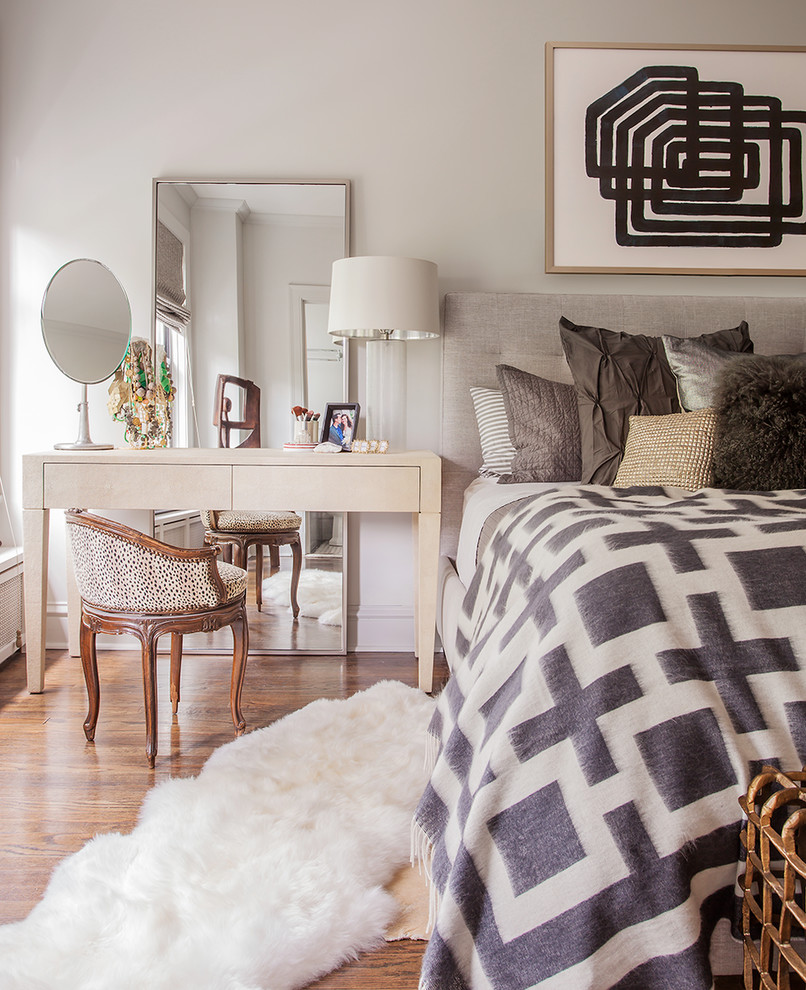 Inspiration for a mid-sized contemporary guest medium tone wood floor bedroom remodel with gray walls and no fireplace