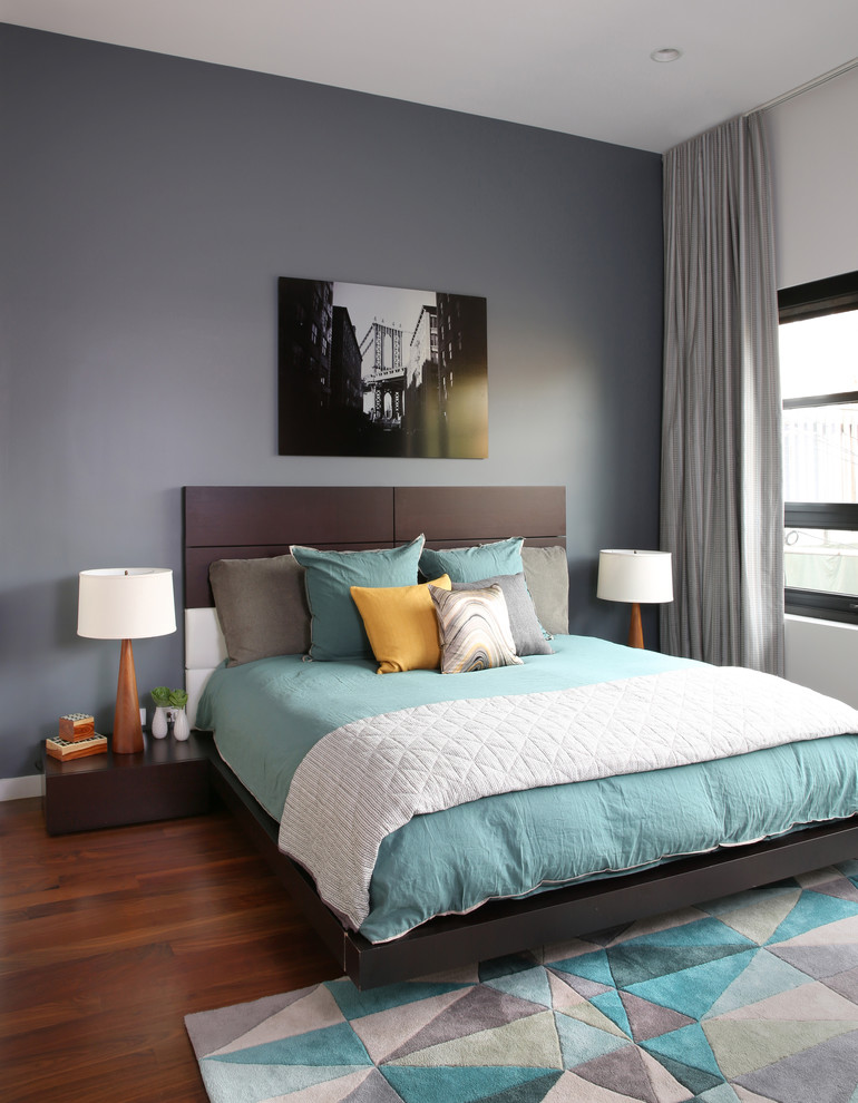 Immagine di una camera da letto design con pareti grigie