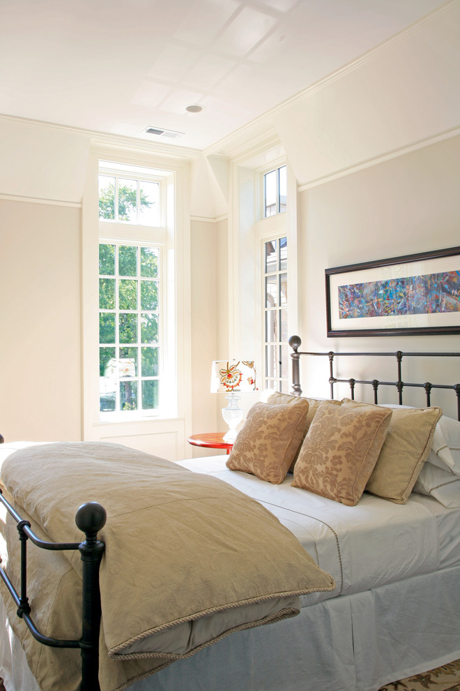 Modelo de habitación de invitados tradicional grande con paredes beige y suelo de madera oscura