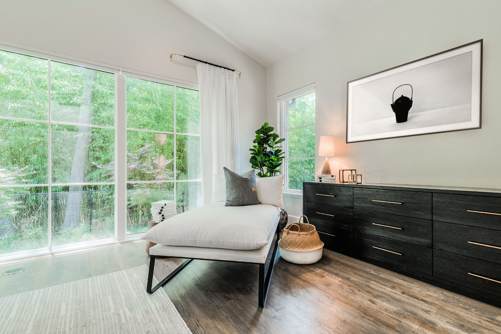 Example of a large trendy master medium tone wood floor bedroom design in Dallas with white walls and no fireplace