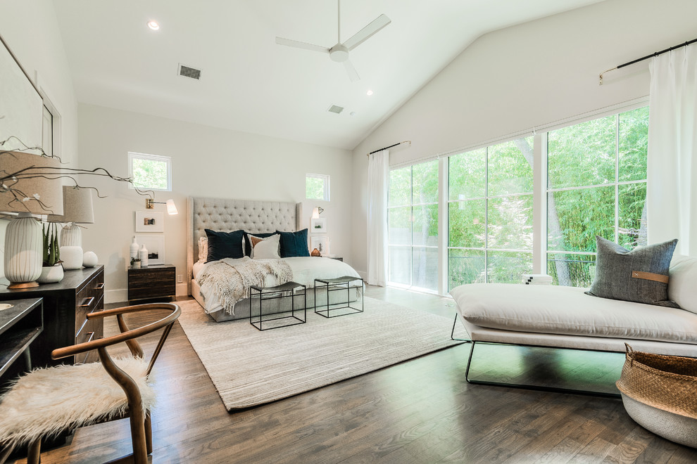 Bedroom - large contemporary master medium tone wood floor bedroom idea in Dallas with white walls and no fireplace