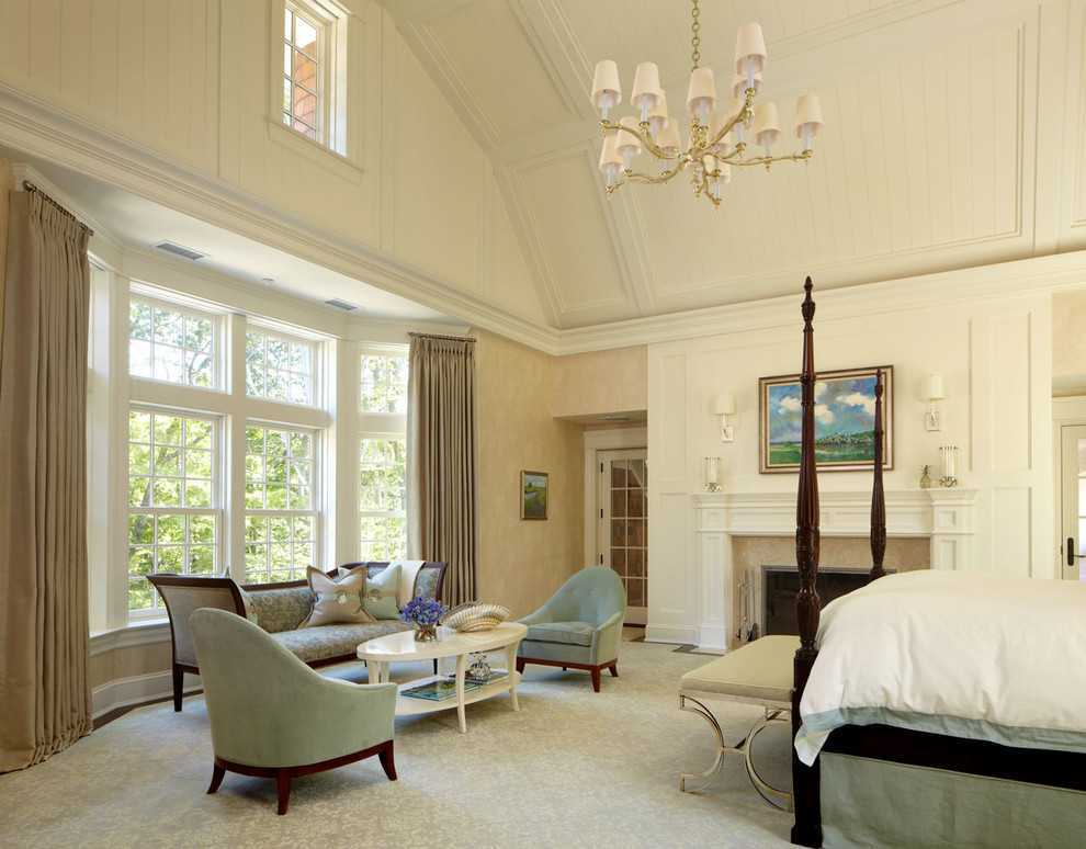 Classic master bedroom in New York with beige walls, carpet, a standard fireplace and a stone fireplace surround.