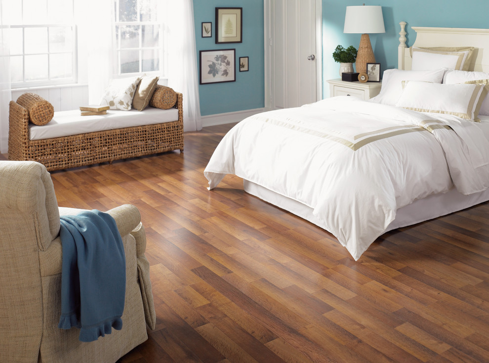 Large beach style master laminate floor and brown floor bedroom photo in San Diego with blue walls and no fireplace